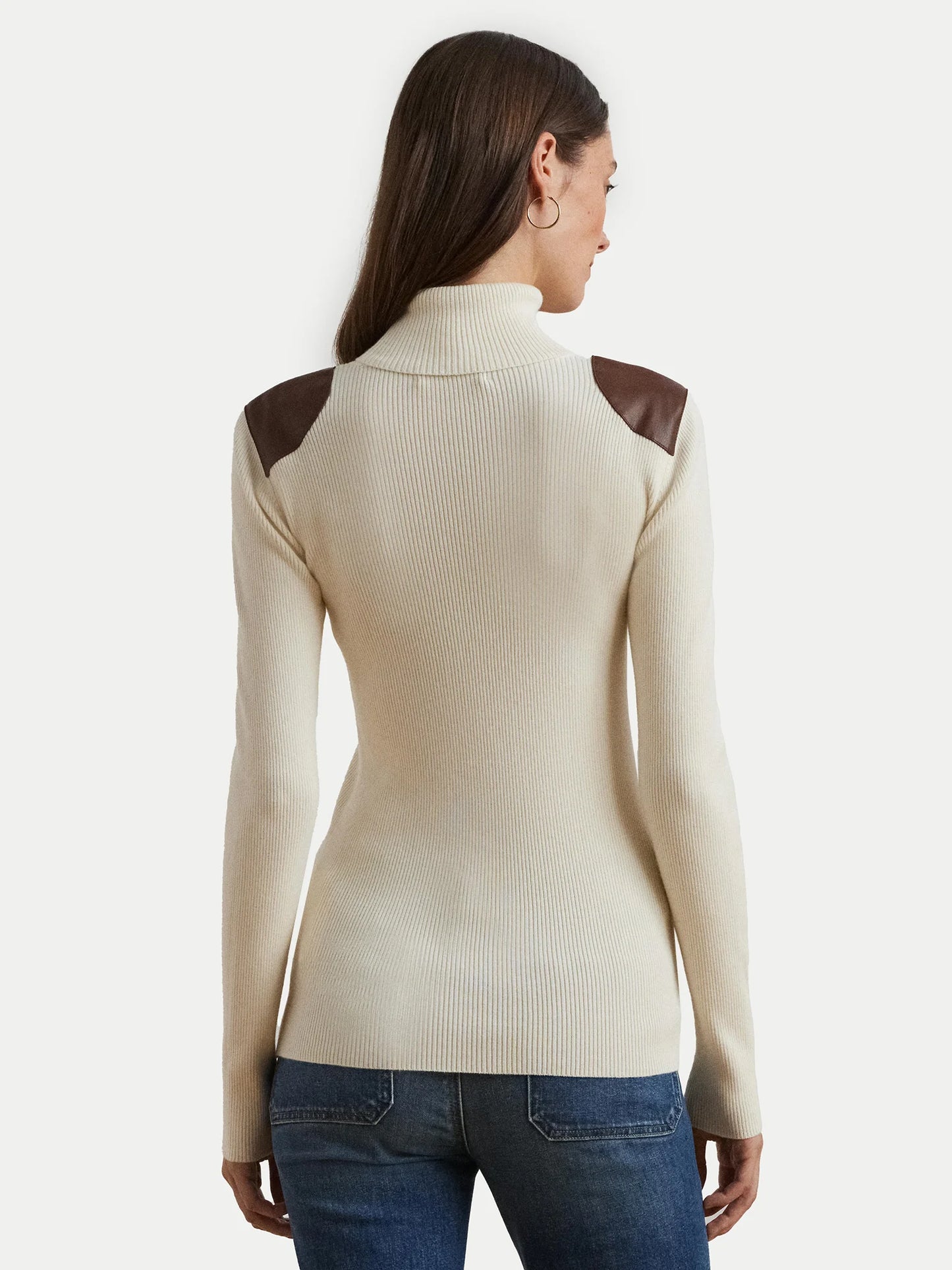 Turtleneck sweater with faux leather flaps. Camel