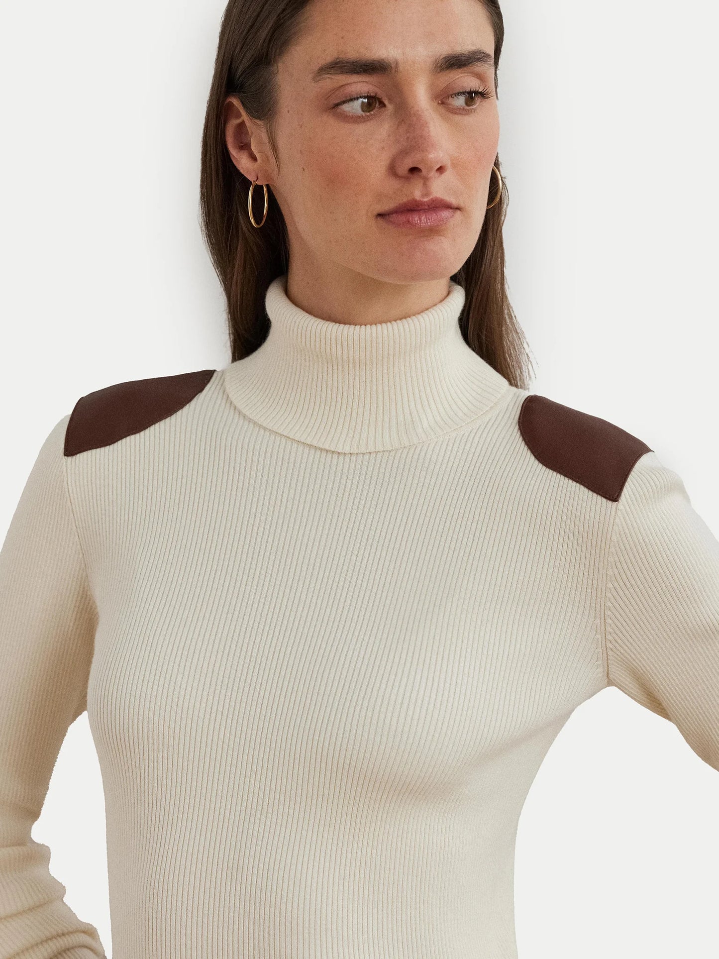 Turtleneck sweater with faux leather flaps. Camel