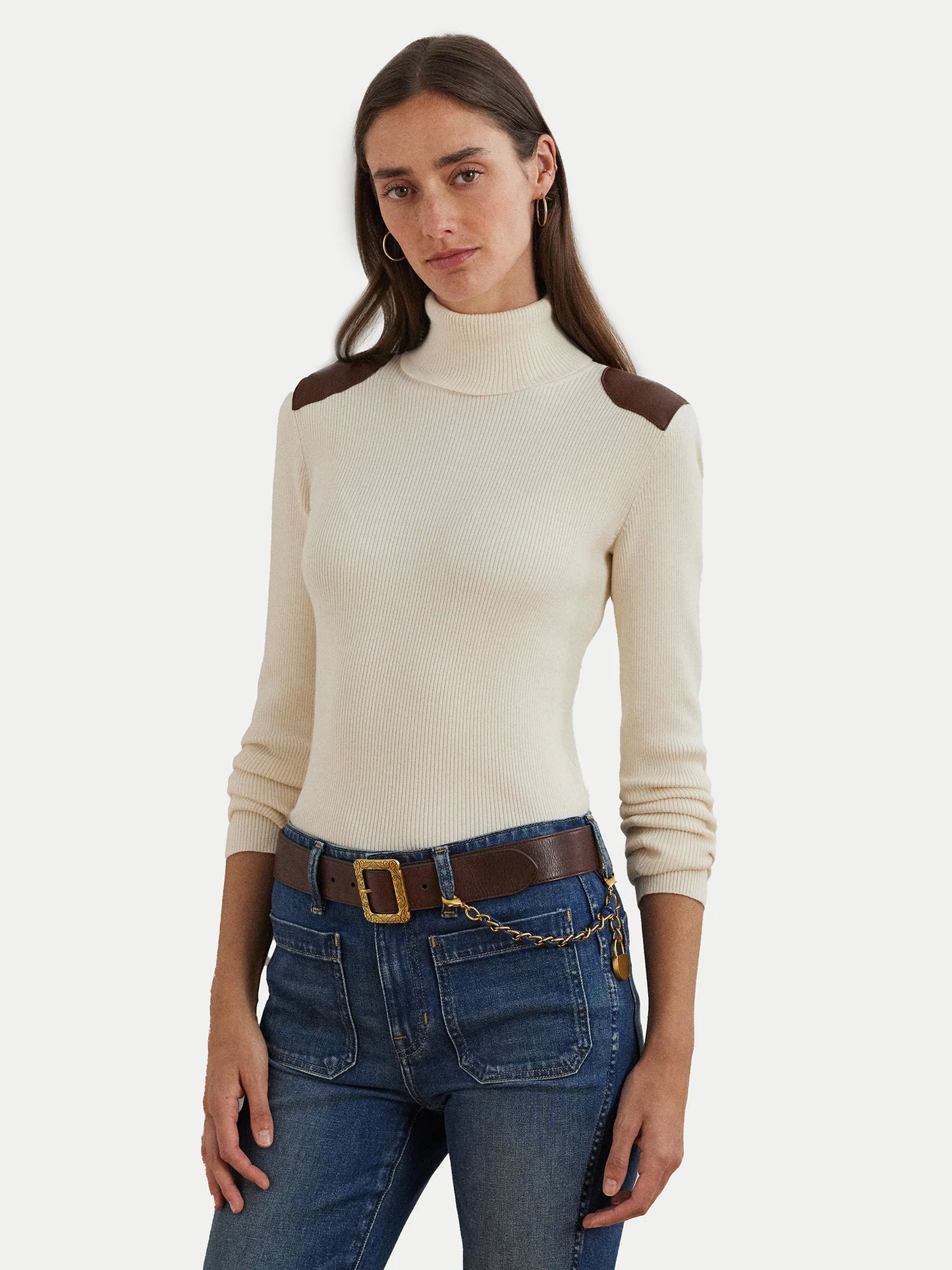 Turtleneck sweater with faux leather flaps. Camel