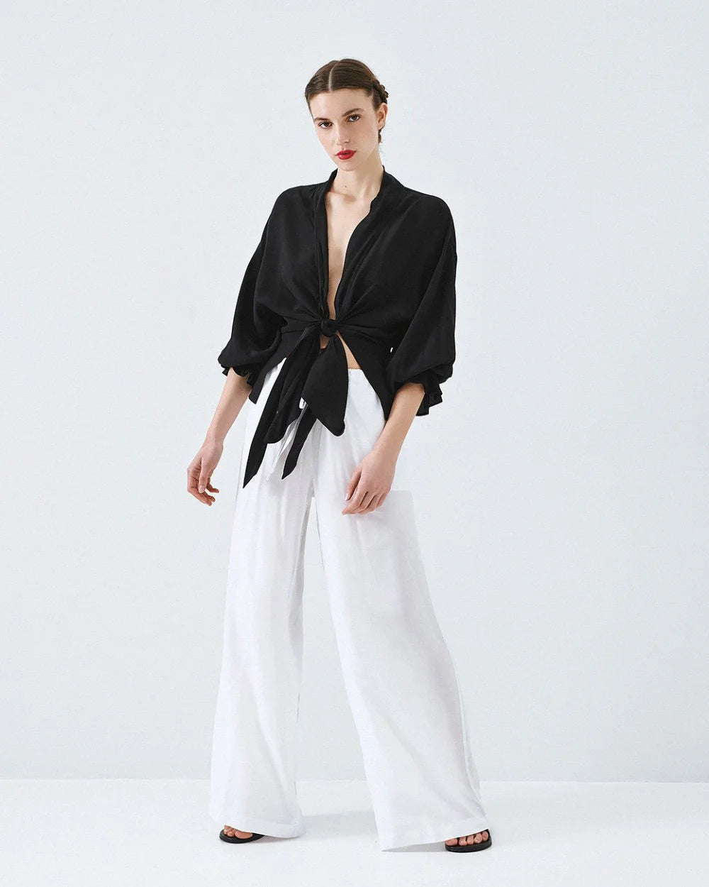 Kimono shirt with tie closure and flounced sleeves.
