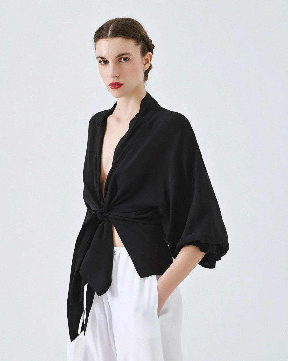 Kimono shirt with tie closure and flounced sleeves.