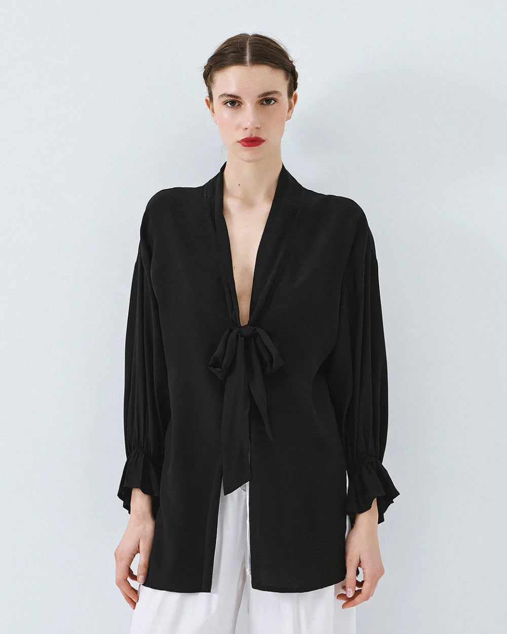 Kimono shirt with tie closure and flounced sleeves.