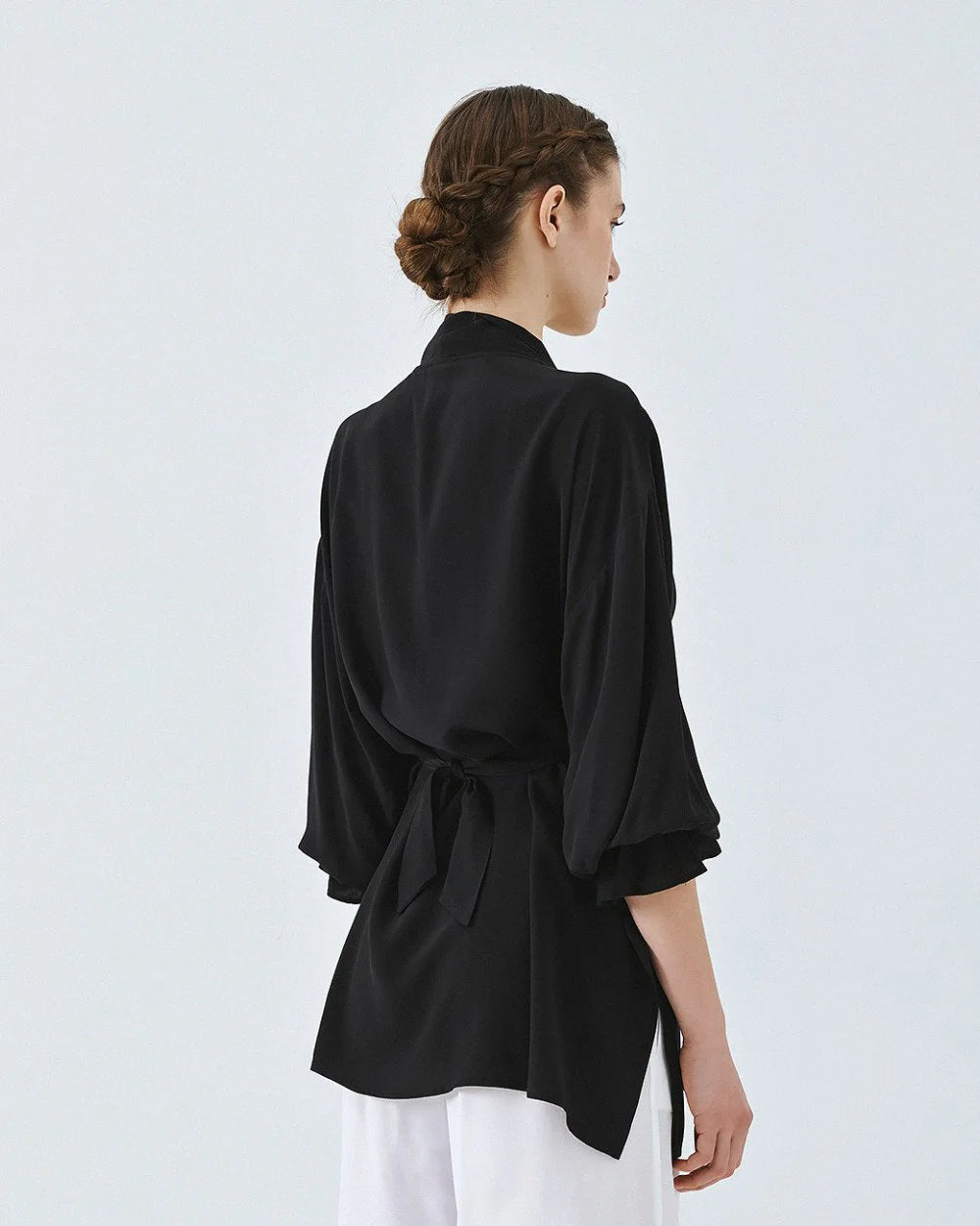 Kimono shirt with tie closure and flounced sleeves.